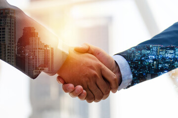 Wall Mural - Investor. double exposure image of investor business man handshake with partner for successful meeting deal with during sunrise and cityscape background, investment, partnership, teamwork concept