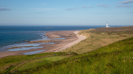 Covesea Lighthouse on Lossiemouth West Beach across Covesea 9 Hole Golf Course