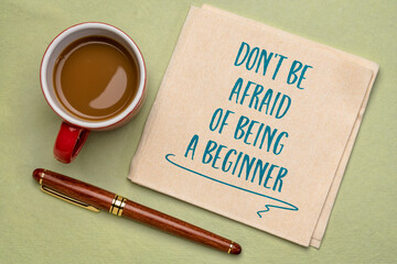 Wall Mural - do not be afraid of being a beginner - inspirational handwriting on a napkin with a cup of coffee, open mindset and personal development concept