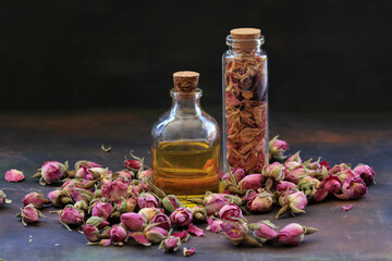 Sticker - Small rose buds and rose oil in bottle on wooden table