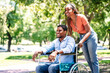 © Mego-studio - Man in a wheelchair enjoying a walk with his girlfriend.