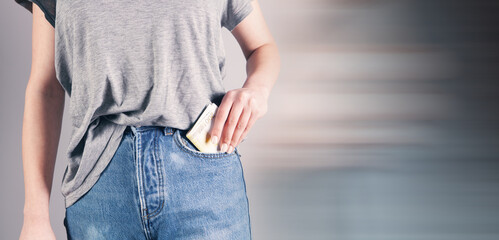 Wall Mural - girl hand putting money in jeans pocket