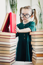 Caucasian Little Child Girl In Green Dress And Glasses Procrastination While Reading Book