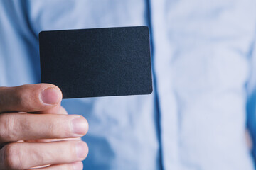 man holding a small paper in his hand