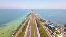 Highway or Freeway road. Ocean or Gulf of Mexico. Road for cars and truck. Low traffic on the way. Highway for any transportation. Best US American roads for travels. Skyway bridge FL. Aerial view