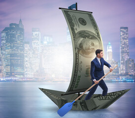 Wall Mural - Businessman rowing on dollar boat in business financial concept