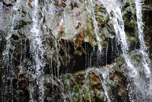 Closeup Of Falling Water Over Rocks