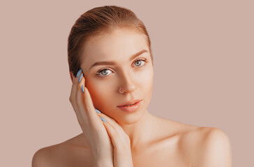 Wall Mural - beautiful sensual young girl with clean skin on a beige background with a mockup. topless woman. the