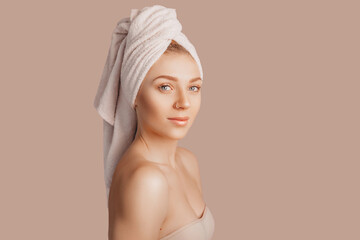 Wall Mural - beautiful sensual young girl with clean skin on a beige background with a mockup. topless woman in a