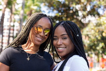 beautiful young afro sisters smiling together