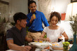© torwaiphoto - Asian group friends eating dinner at home, they are happy to talk.