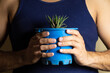 © Narayan - man holding a potted plant for decoration, houseplant concept