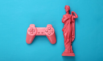 Wall Mural - Pink gempad and antique greek statue on blue background. Gaming concept, minimalism. Flat lay. Top view