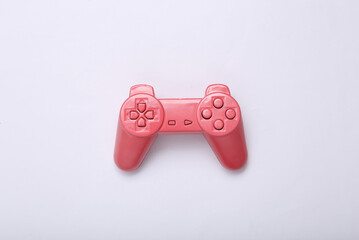 Wall Mural - Creative gaming layout. Pink retro gamepad on white background. Minimalism. Concept art. Modern still life. Flat lay. Top view.