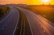 Empty highway at sunset