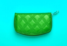 Green Wallet On Blue Background. Top View. Fashion Minimalism