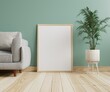 © redrabbit007 - Photo frame mockup on the wooden floor in the living room With plant pots and sofas on the floor beside.3d rendering.