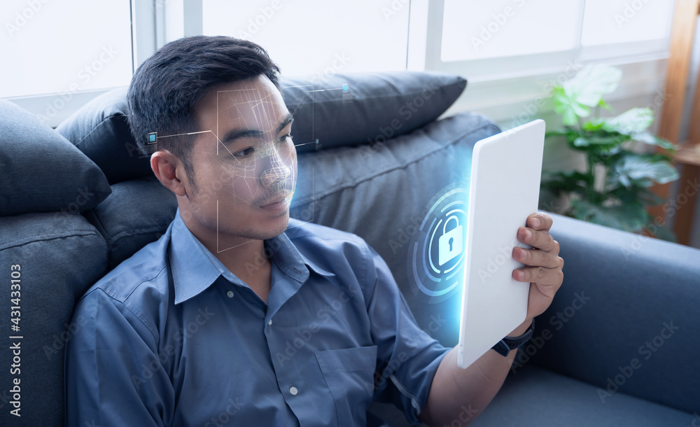 Face detection AI technology, facial recognition security user identification access, Asian man working home using tablet, smart scanning sensor environment surrounding concept, 3d model wireframe.