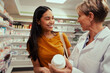 © StratfordProductions - Senior pharmacist assisting of buying medical drug to buyer in pharmacy drugstore