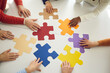 © Studio Romantic - Business team looking for solution to problem. Diverse people join colorful puzzle parts as symbol of teamwork. Group of workers put colorful jigsaw pieces together as metaphor for creative search
