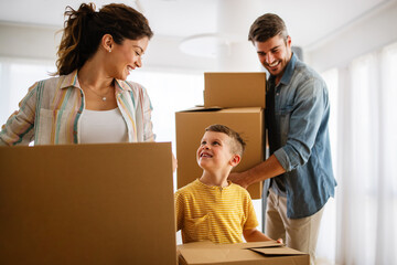 Wall Mural - Family unpacking cardboard boxes at new home