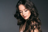 Fototapeta Panele - Long hairwoman beautiful face young female  model over dark background