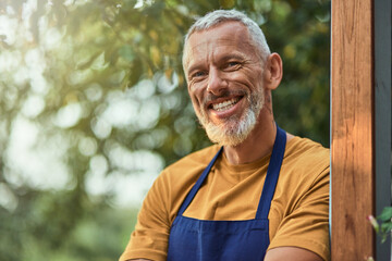 Middle aged caucasian businessman standing in garden