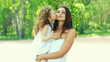 © rohappy - Little daughter child kissing her loving mom in a summer park