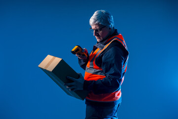 Poster - A worker reads a barcode from a cardboard box. A storekeeper with a barcode reader. A convenient way to get product information. Encoding of product information. Warehouse accounting of goods.