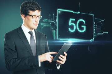 Poster - Augment reality concept with businessman with digital tablet and virtual 5g inscription on dark background.