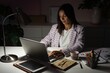 © opolja - Confident Young Indian Mixed-race Businesswoman Working in Office at Night. Girl Working Overtime