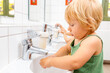 © Kzenon - Child in kindergarten washing her hands