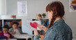 © TommyStockProject - Close up of preteen schoolgirl holding paper with red painted heart standing in classroom