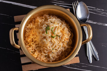 Wall Mural - spicy instant noodle in a golden pot with mozzarella cheese