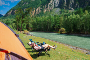 Wall Mural - woman lying down in the camping chair