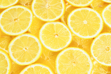 A slices of fresh juicy yellow lemons.  Texture background, pattern.