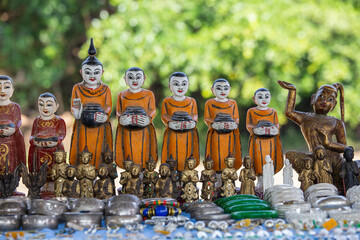 Wall Mural - Handmade monk figurine and other souvenir in a tourist stall on the street market near Inle Lake in Burma, Myanmar