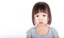 Portrait Of Cute Little Asian Toddler Girl Isolated On White Background. Close Up Face Of Moody Angry Little Terrible Two Japanese Girl, Preschool Student, Education Lifestyle Concept