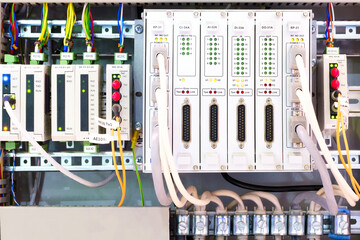 Poster - View of communication port module on PLC unit in control box of automation machine