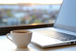 © Oleg - Cozy workplace in home office with hot coffee cup and laptop on table against the window at sunrise. Good morning, concept of remote work and earning online