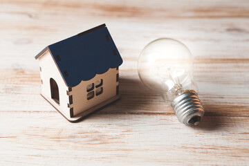 house and light bulb on the table