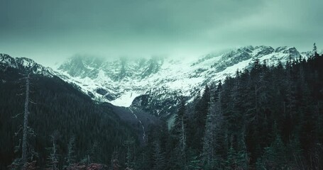 Wall Mural - dramatic timelapse of storm clouds over mount shuksan at dusk