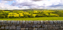 English Countryside And Farmland Landscape Panorama Background Along Hadrian's Wall Roman Ruin. Beautiful Rural Country Side Pastures In England