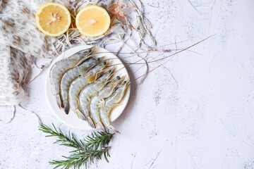 Wall Mural - Raw shrimps prawns on white plate, Fresh shrimp seafood with herbs and spice - top view