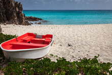 Small Red Rowboat On The Sand On The Caribbean Island Of St Bart's