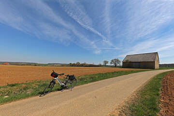 Wall Mural - E-bike on the sandy road against the blue sky in spring