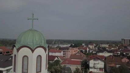 Wall Mural - An aerial view of a church and colorful buildings near the river under a clear sky