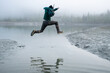 © SuperStock - Jumping over a gap at the Mendenhall Lake