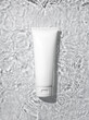 White cosmetic tube on the water surface. Blank label for branding mock-up. Summer water pool fresh concept. Flat lay, top view.	