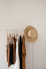 Wall Mural - Women's fashion bright pastel clothes on clothing rack on white background. Minimalist fashion blog concept.